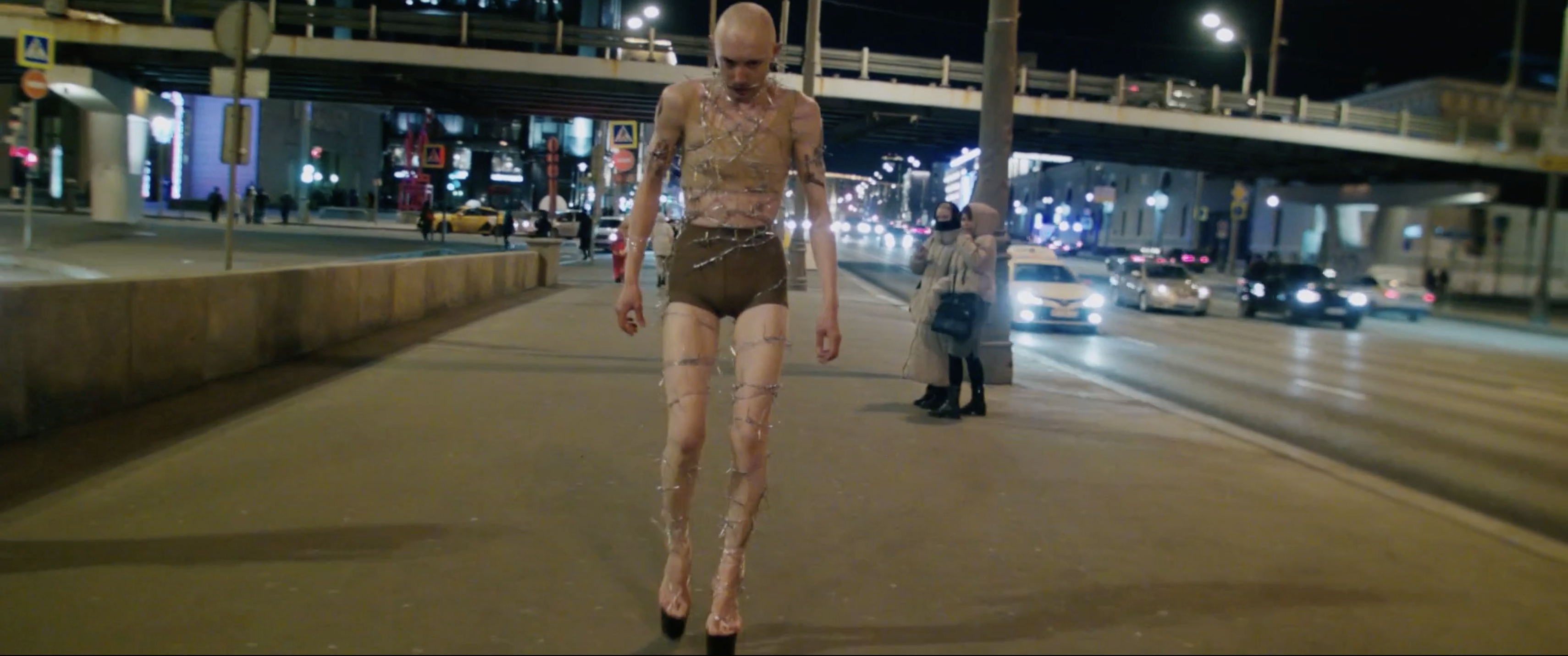 the artist walking in barbed wire